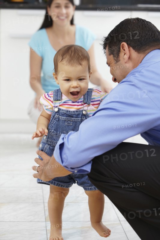 Hispanic father playing with daughter