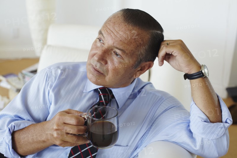 Hispanic businessman drinking coffee