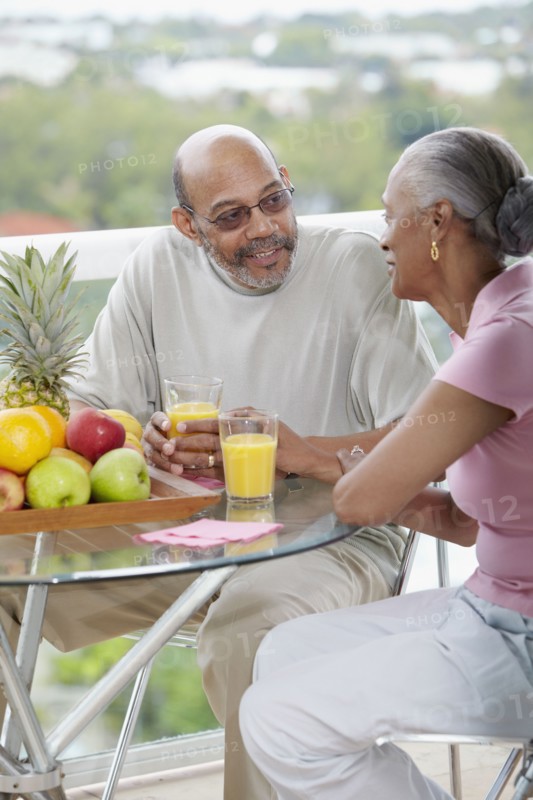 African couple drinking orange juice