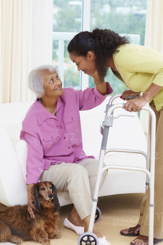 African American woman helping senior mother