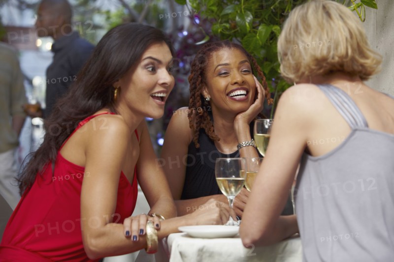 Friends talking over dinner in restaurant