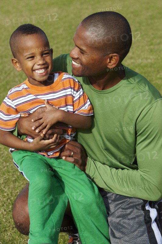 African American father holding son on lap