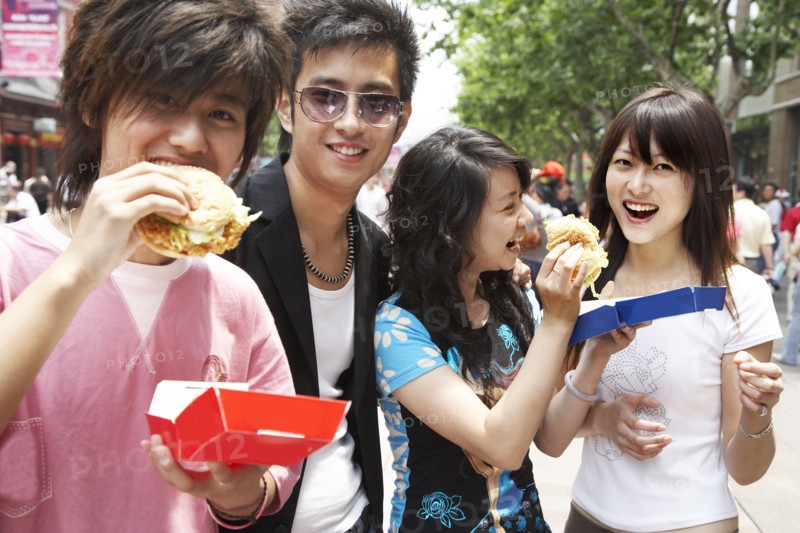 Chinese friends eating fast food together