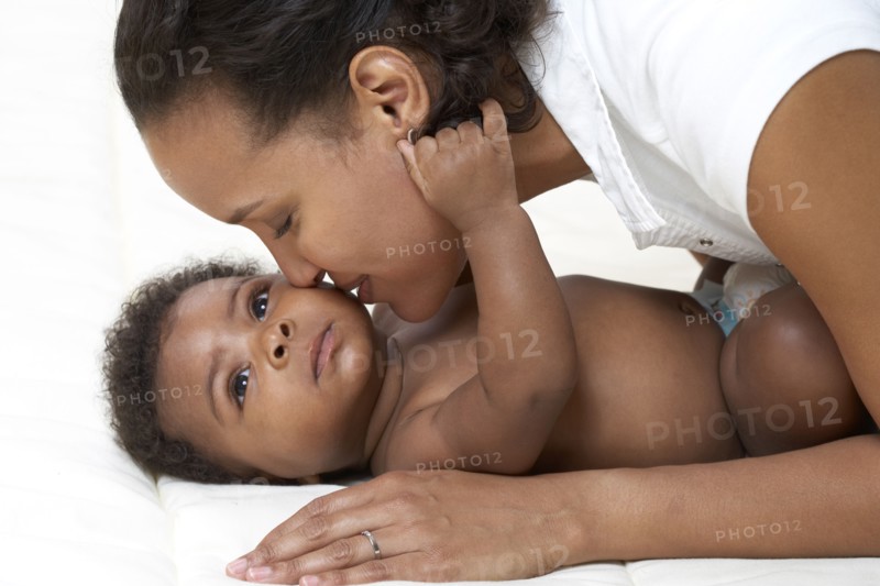 African American mother kissing baby