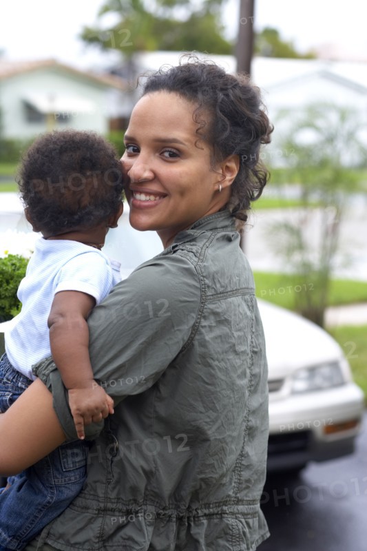 African American mother carrying baby