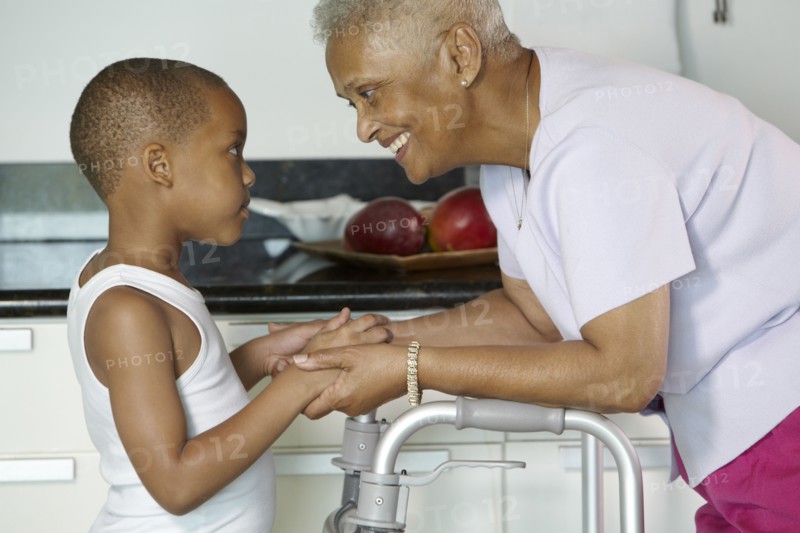 African American grandmother holding hands with grandson