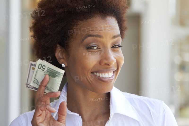 African American woman holding 50 dollar bill