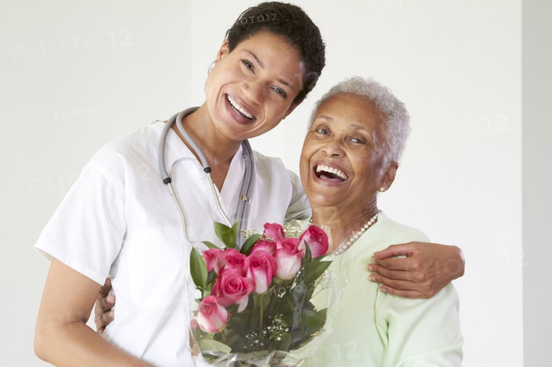 African American woman hugging nurse