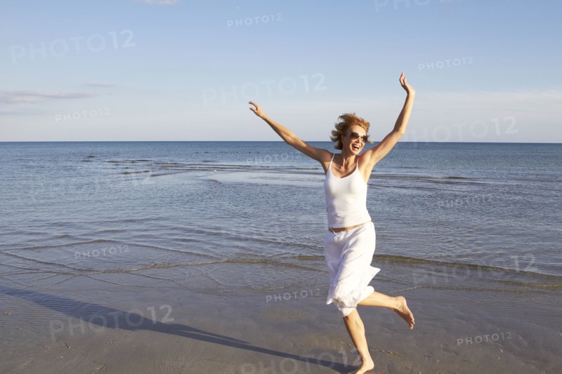 Caucasian woman playing on beach