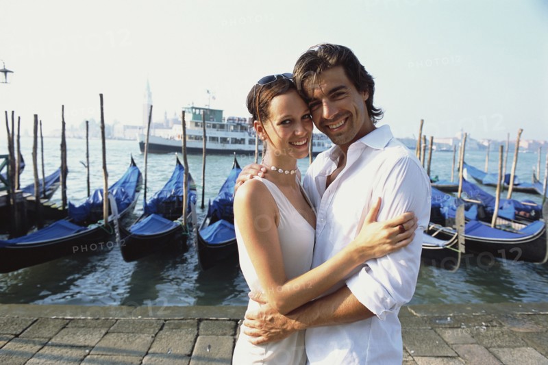 Couple hugging on urban canal front