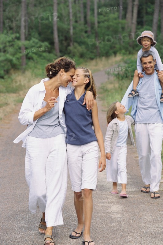 Caucasian family walking in park