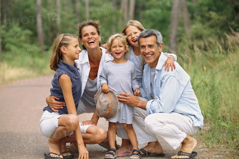 Caucasian family smiling in park