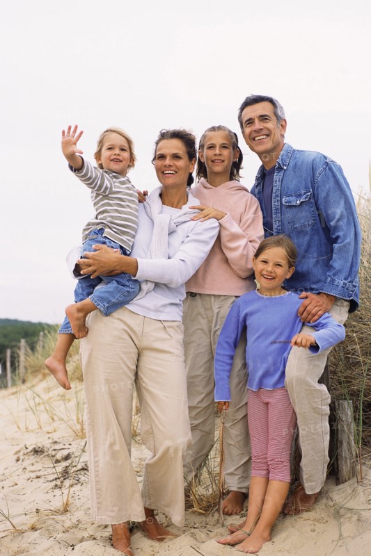 Caucasian family smiling on beach