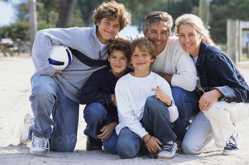 Family smiling together in park