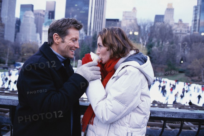 Couple sharing coffee outside Rockefeller Center
