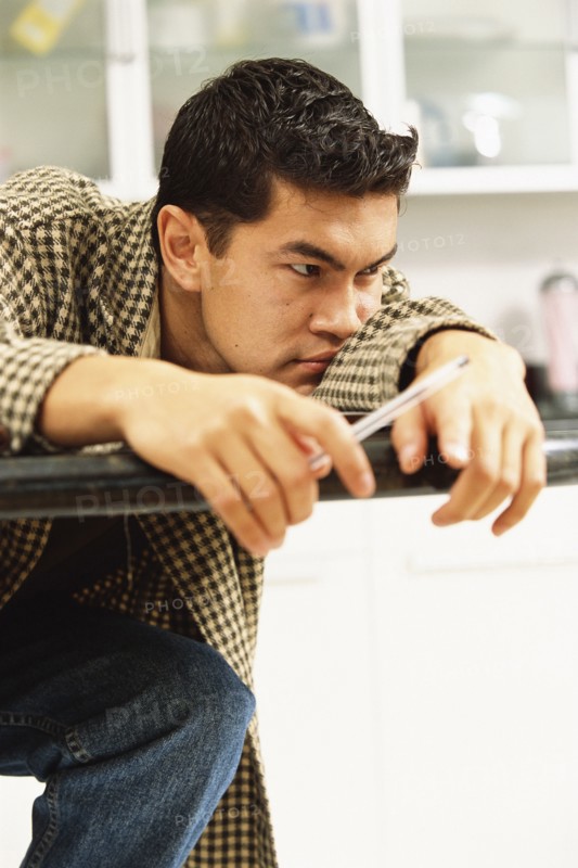 Bored man laying on counter top