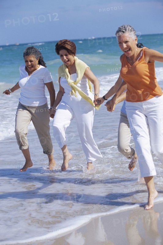 Senior women running on beach