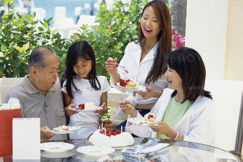 Family eating cake together at birthday