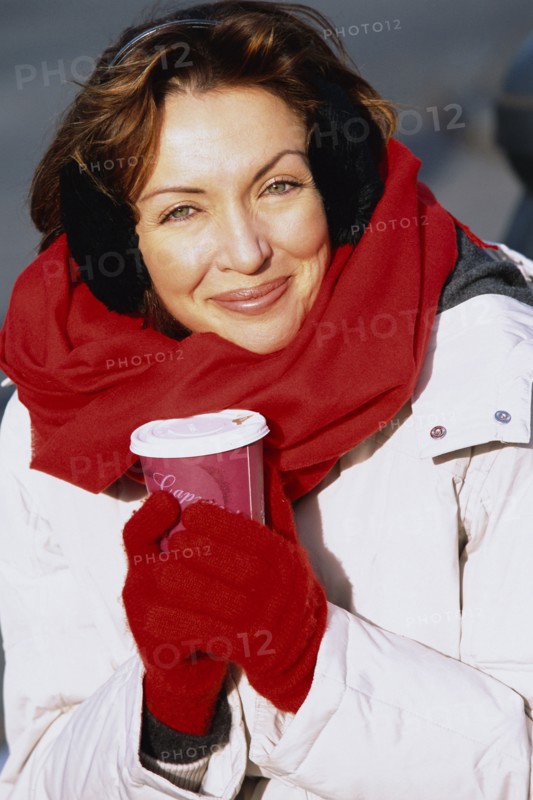 Woman drinking coffee outdoors
