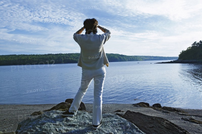 Senior woman overlooking rural lake