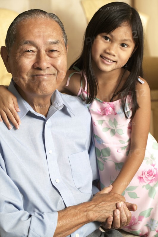 Senior man and granddaughter holding hands