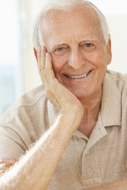 Senior man resting chin in hand