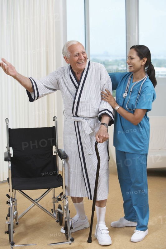 Nurse helping Senior patient use cane