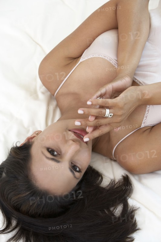 Indian woman laying on bed