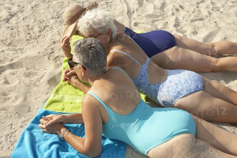 Senior women laying on beach
