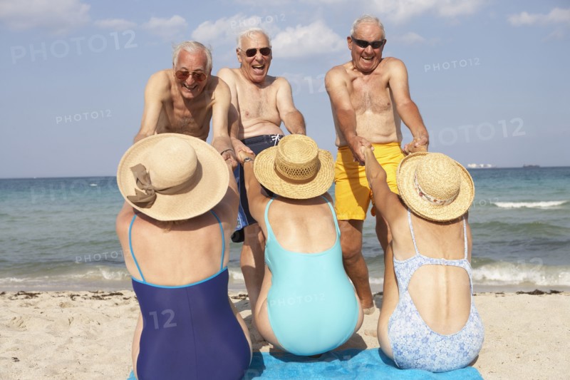 Senior couples playing on beach