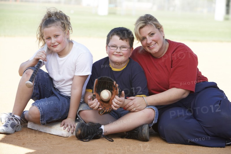 Mother and children smiling outdoors