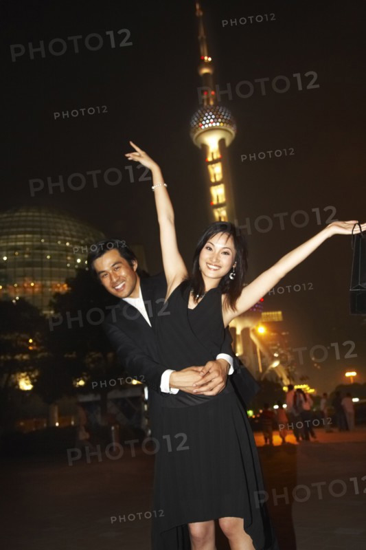 Couple outside Oriental Pearl Tower at night