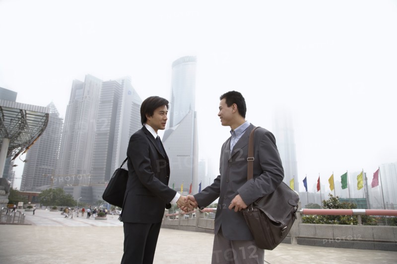 Chinese businessmen shaking hands