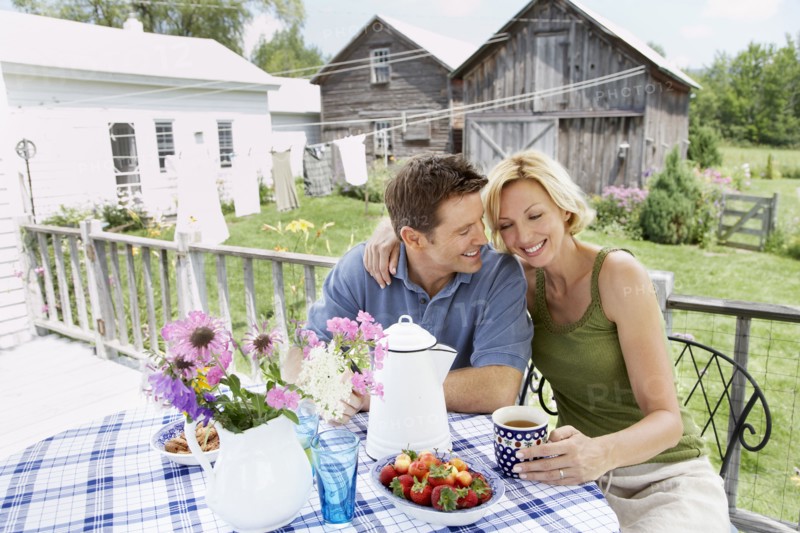 Couple having coffee on patio