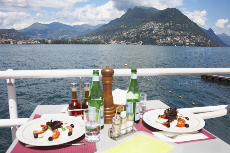 Plates of food at restaurant overlooking rural lake