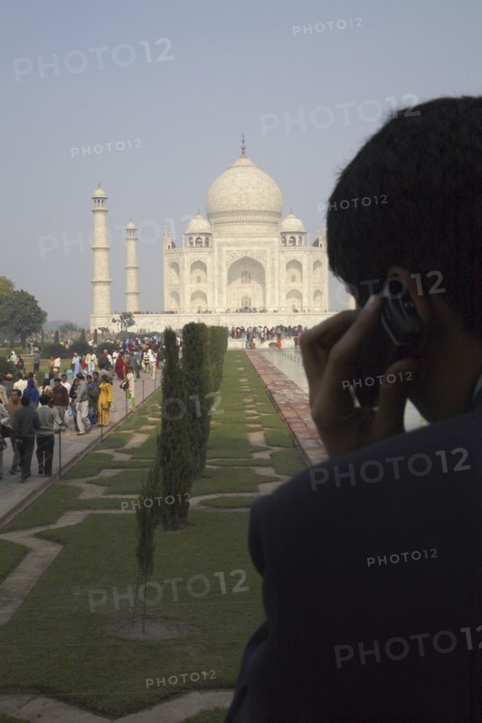Indian businessman on cell phone by Taj Mahal