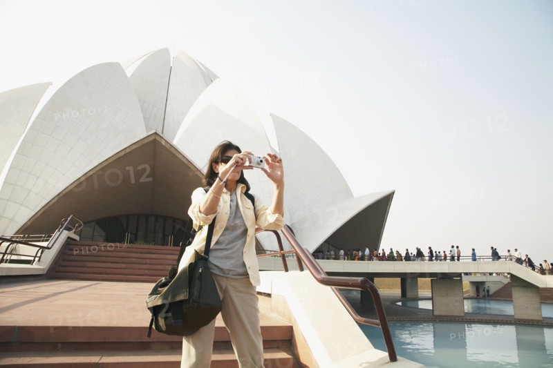 Caucasian tourist taking pictures at Bahai Temple