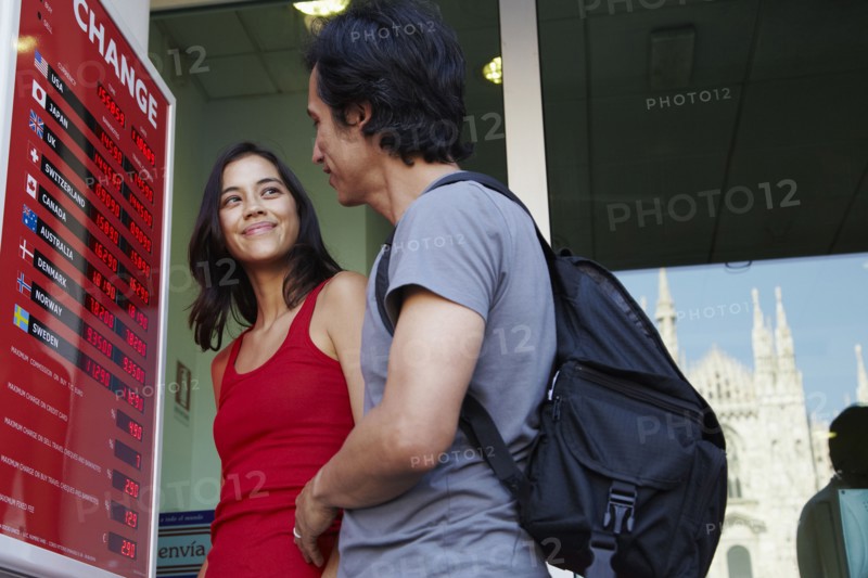Couple checking currency exchange rates