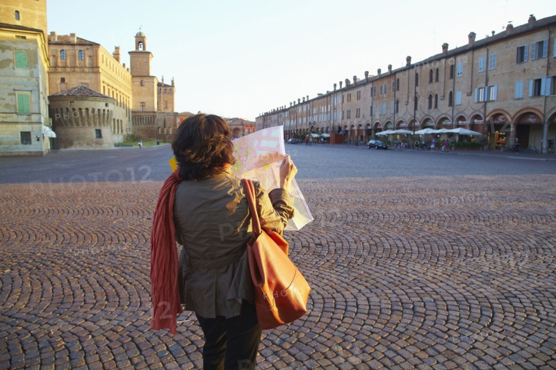 Women reading map in town square