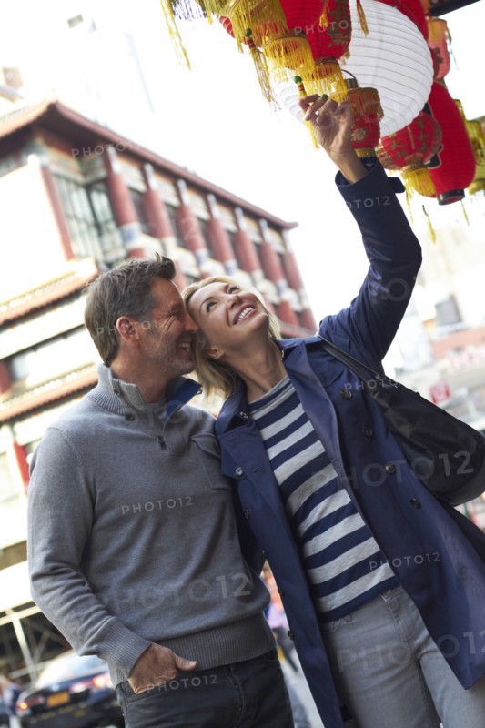 Caucasian couple shopping in Chinatown