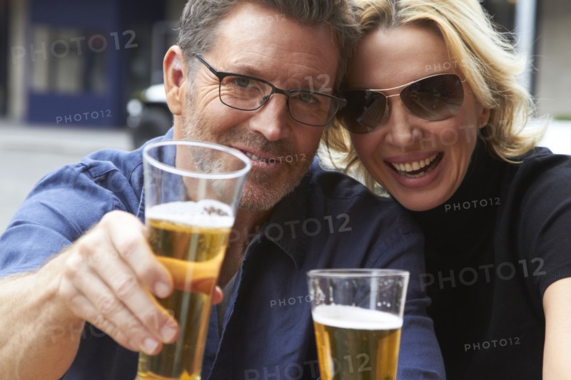 Caucasian couple drinking beer outdoors