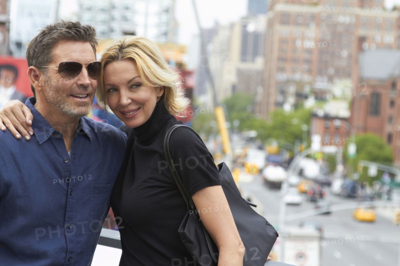 Caucasian couple hugging in city