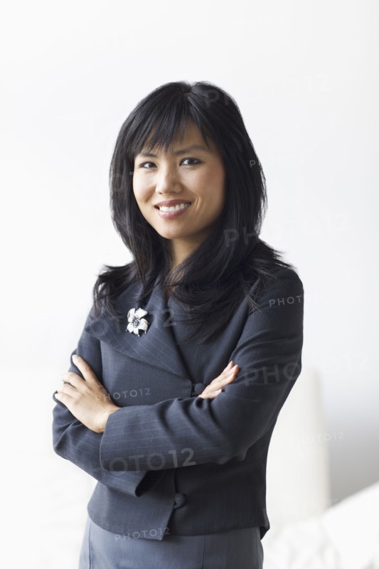 Smiling businesswoman with arms crossed