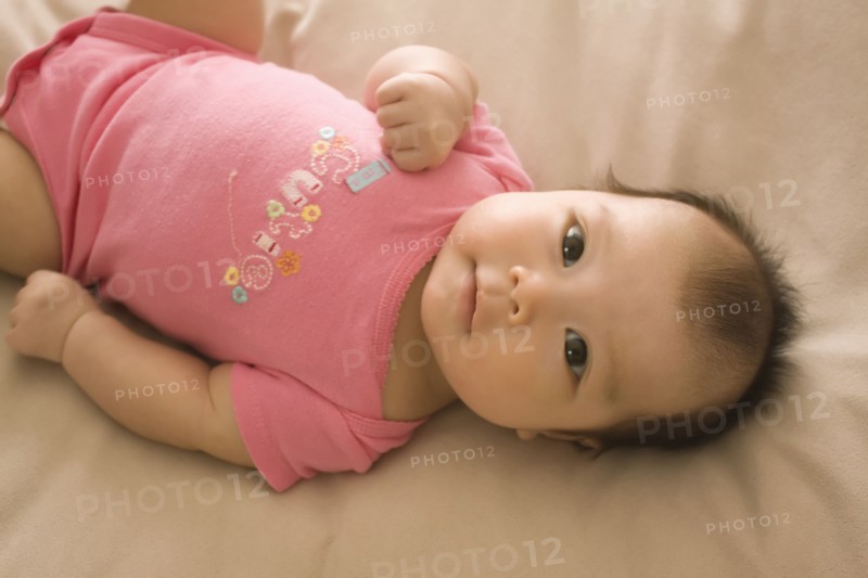 Chinese baby girl laying on bed
