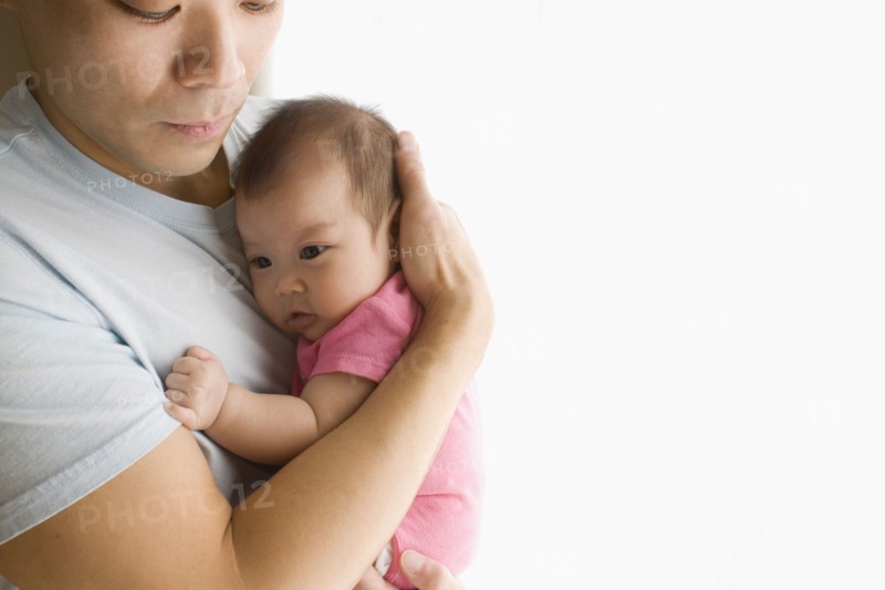 Chinese father holding baby daughter
