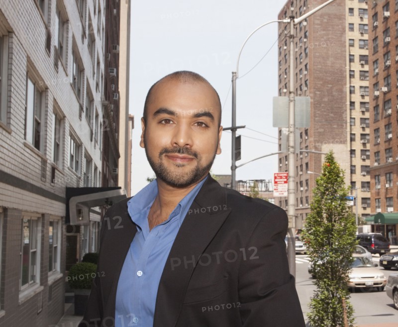 Mixed race businessman standing on urban street