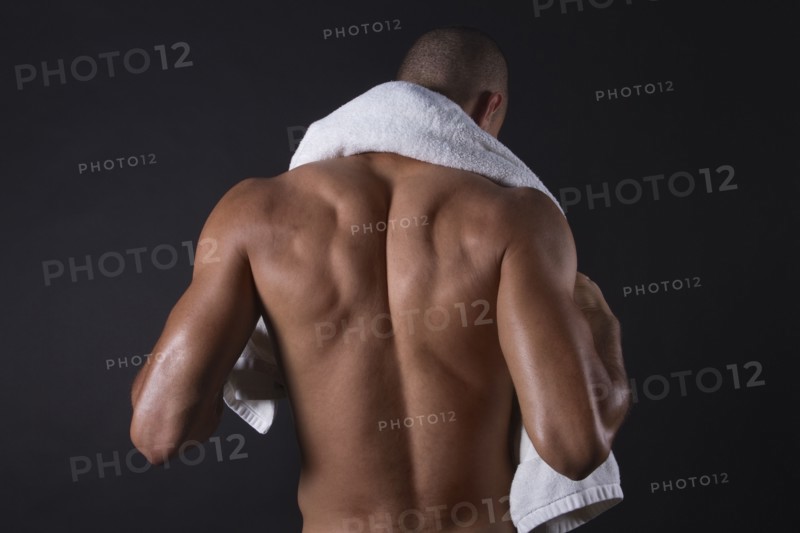 Mixed race athlete standing with towel around neck
