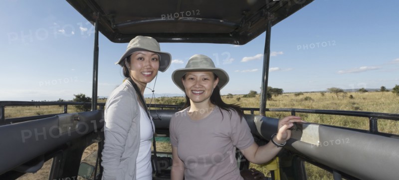 Women riding in truck on safari