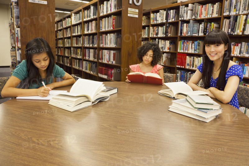 Girls doing homework in library