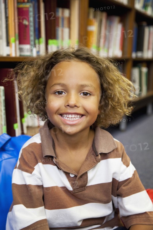 Boy smiling in library